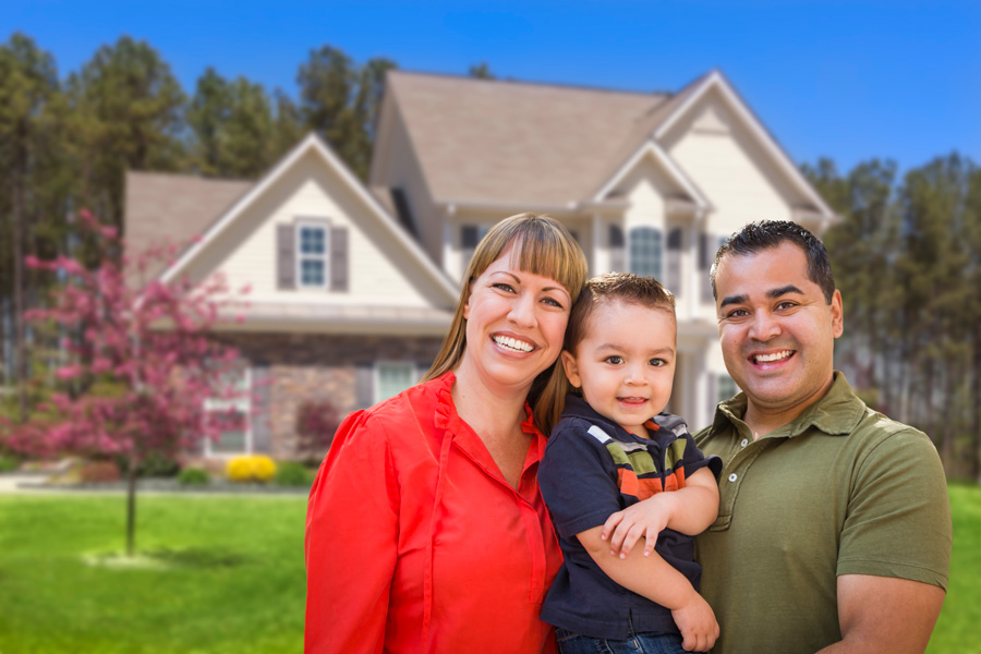 a man, women, and their child smiling outside their home with Homeowners Insurance in Richmond Hill, NY, Middle Village, NY, Forest Hills, NY, Howard Beach, Woodhaven, NY, Far Rockaway
